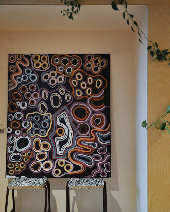 A large painting of looping patterns on the gallery wall