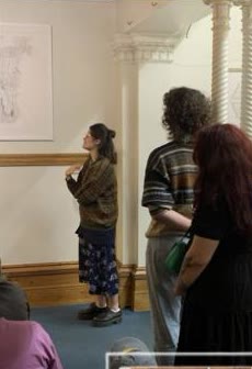Lia giving a curator talk in a gallery