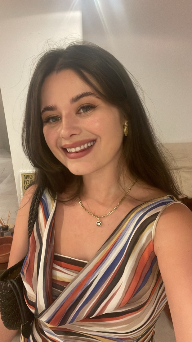 Lia Karabatsos smiling in a striped dress